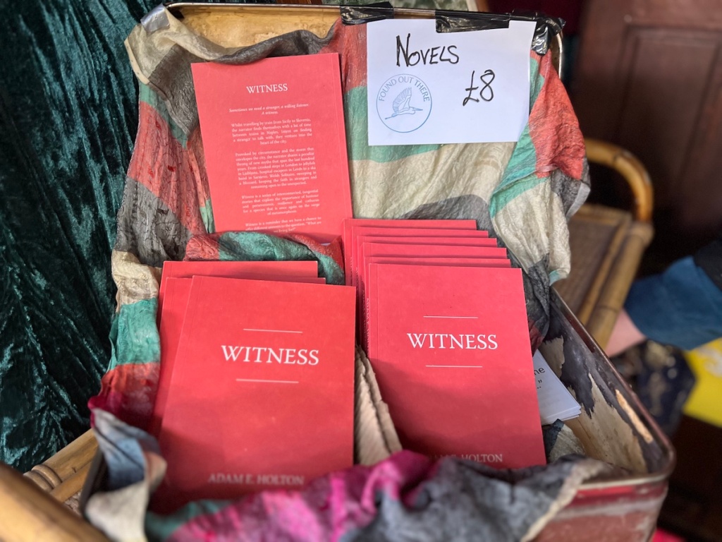 A basket of novels written by Adam Houlton