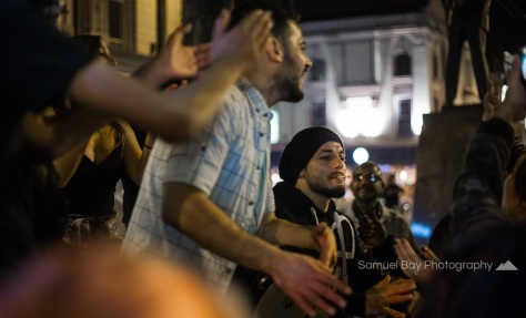 A man plays music on the street while others dance during Hallowe'en celebrations- 1st November 2016 - Queen Street Cardiff, United Kingdom. ©Samuel Bay